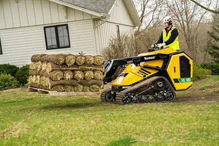 ML180 mini loader carrying pallet of sod